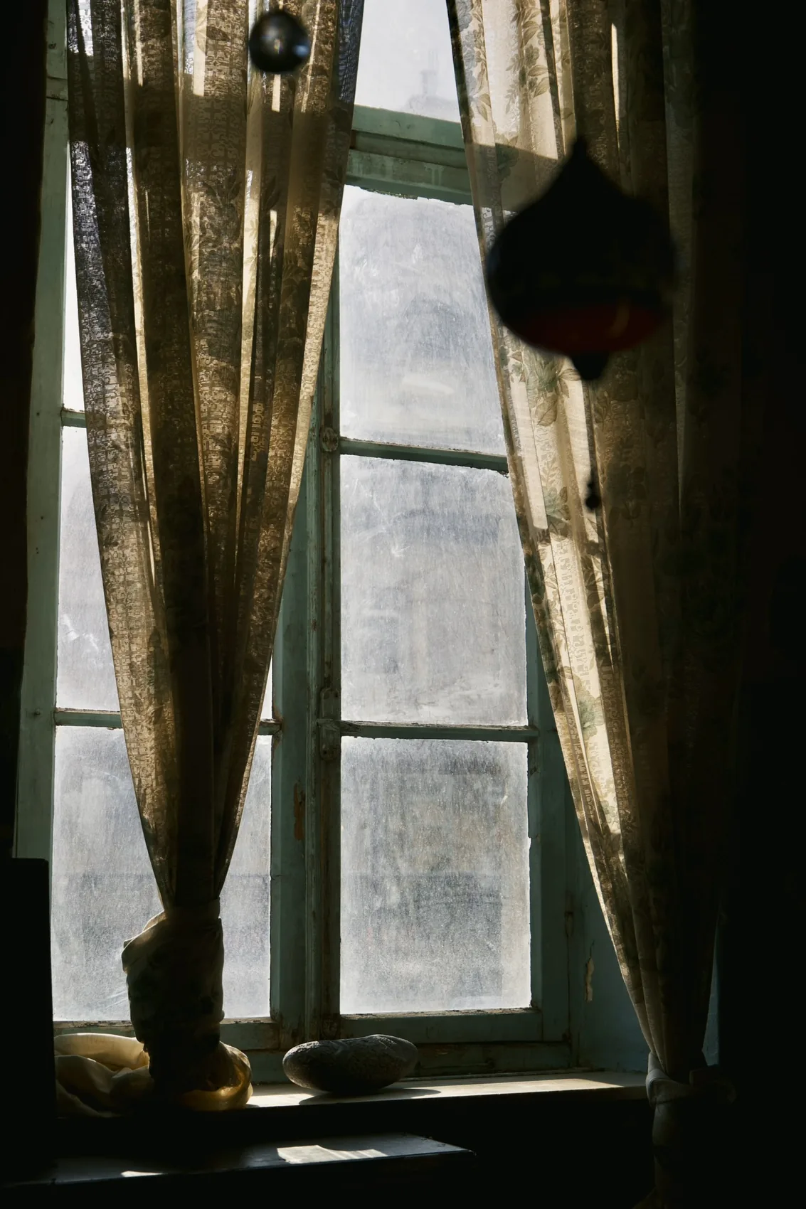 Curtains and window light in an Amman interior.