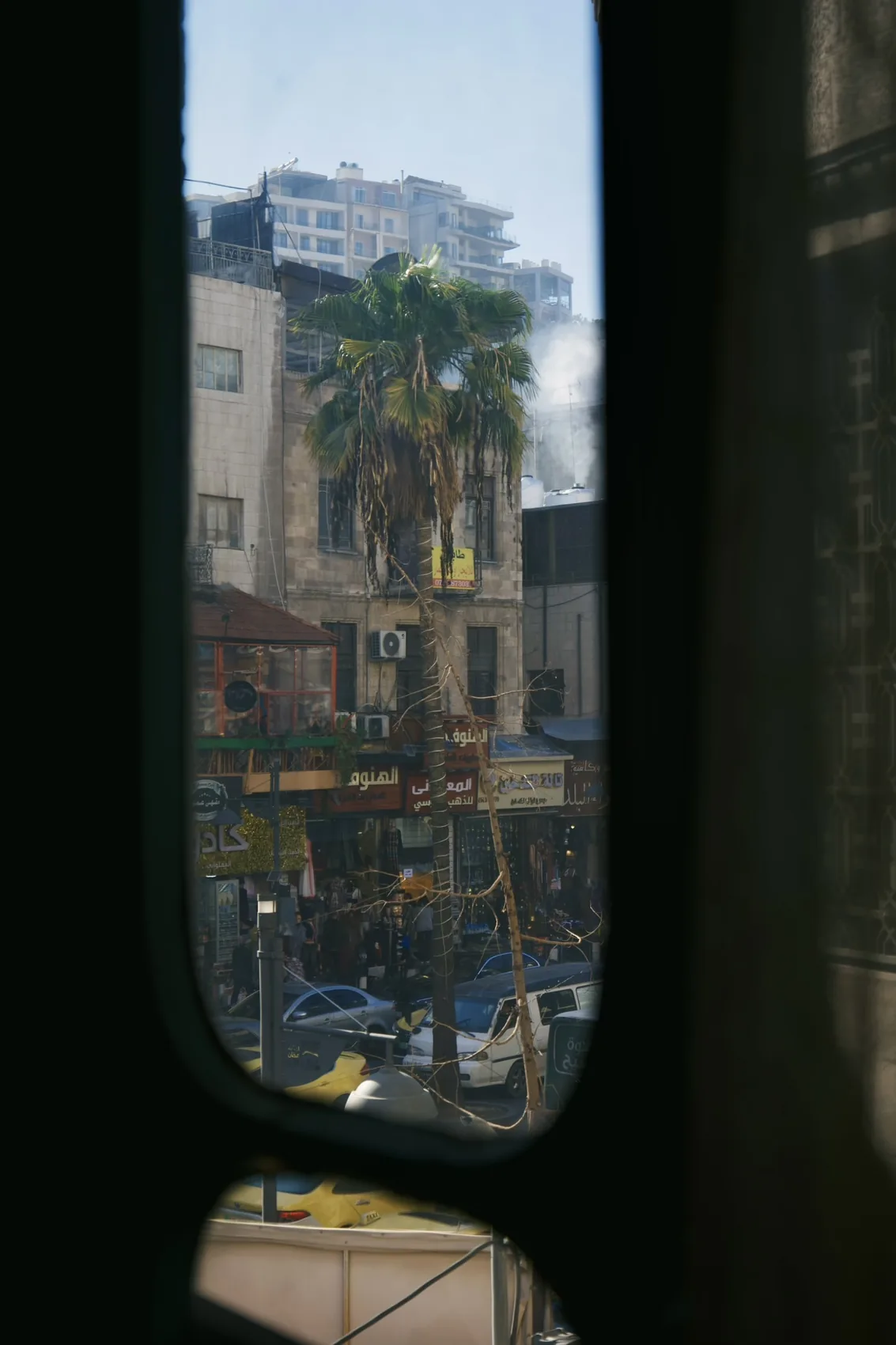 Amman street seen through a dark window.