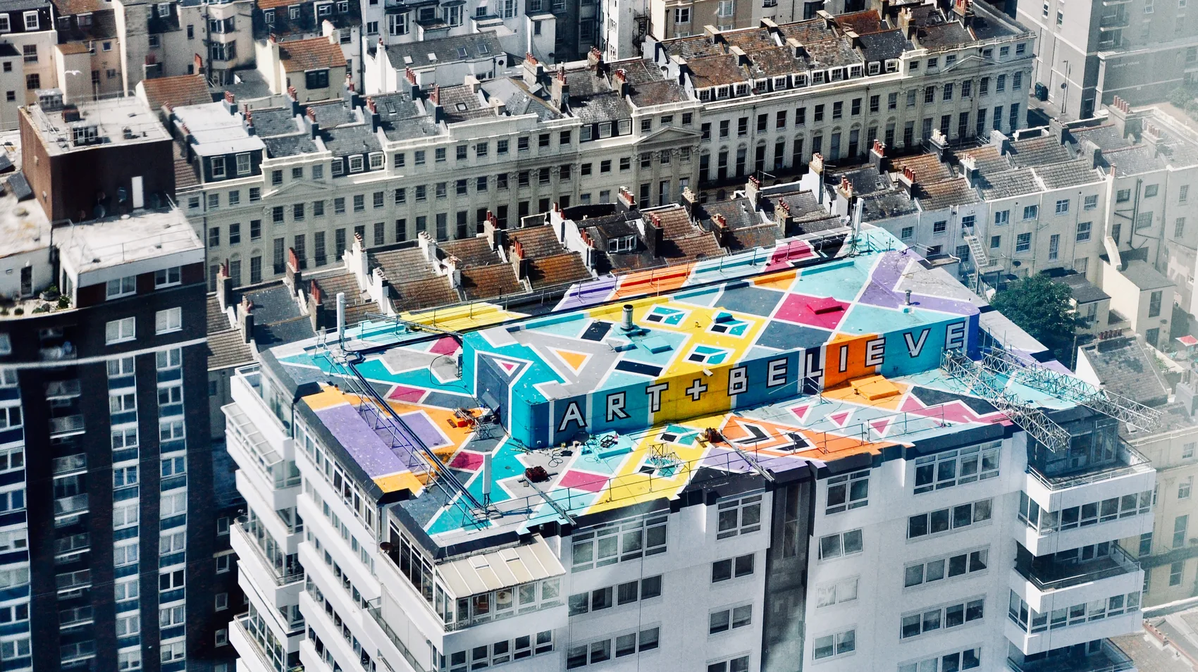 A bright rooftop mural in Brighton seen from above.