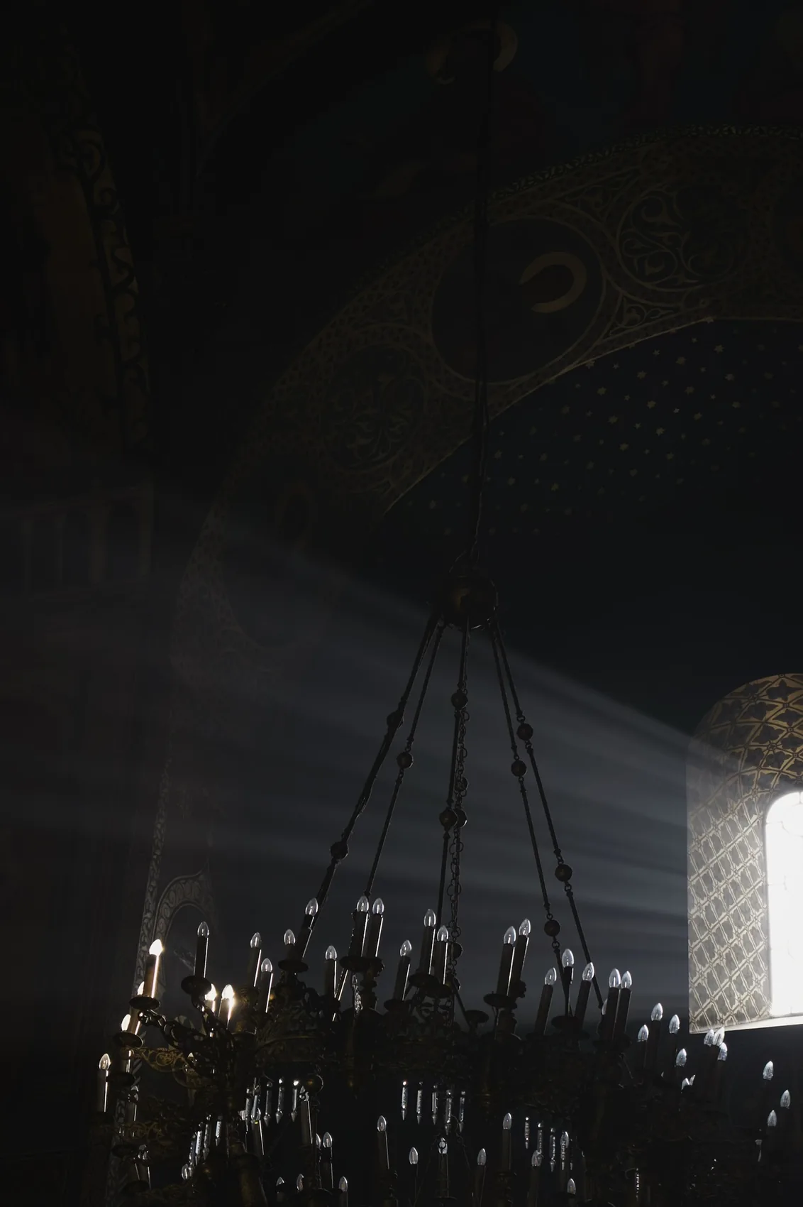 A dark Georgian church interior with a shaft of light.