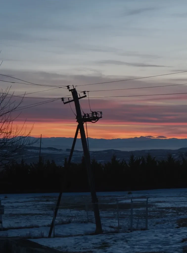 A cross and winter field at sunset in Georgia.
