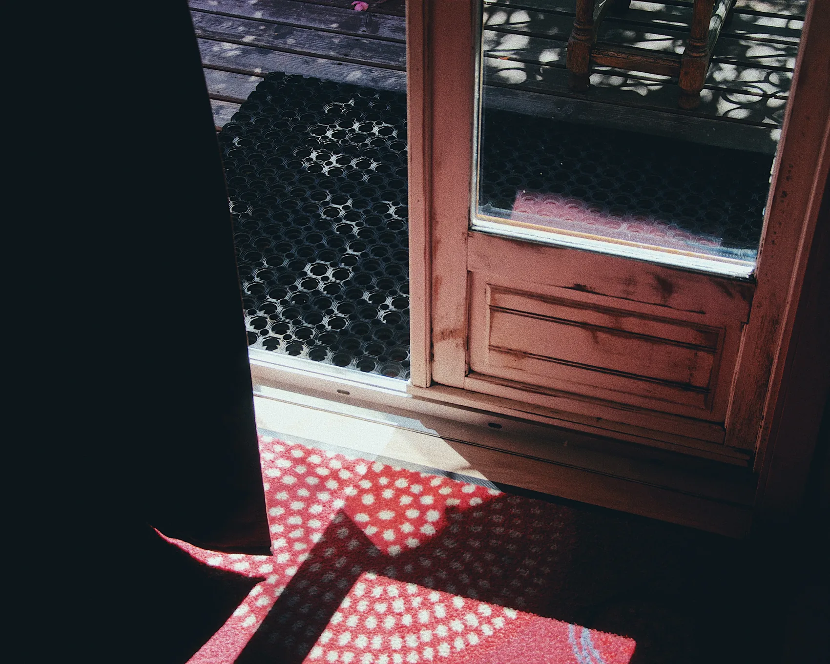 A red patterned floor and door in high Chamonix light.
