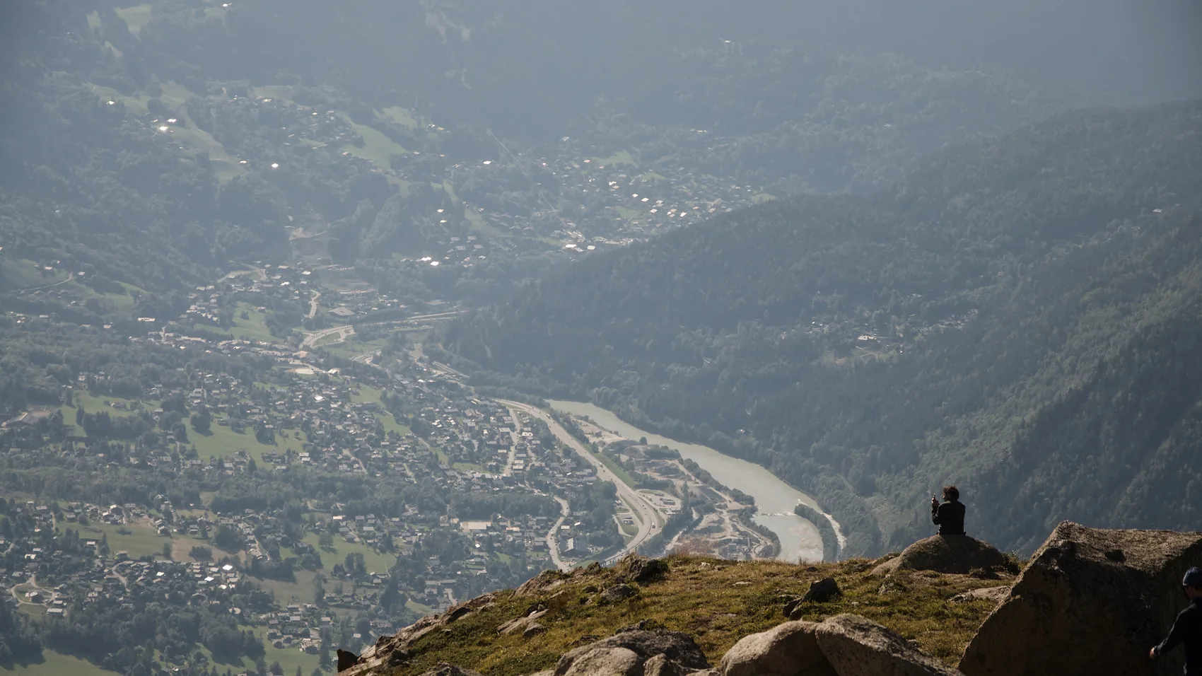 A Chamonix valley seen from a high rocky ledge.