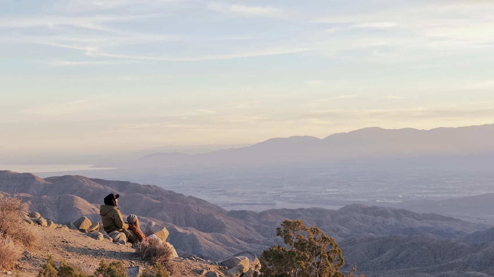 A seated figure overlooking Death Valley in last light.