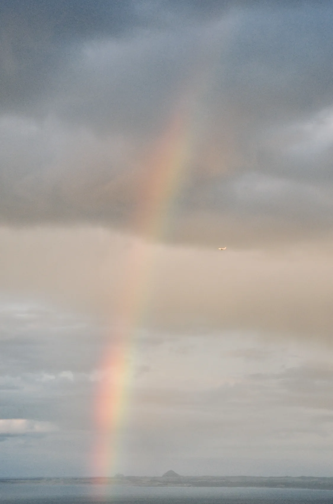 A vertical rainbow under grey Edinburgh rain.