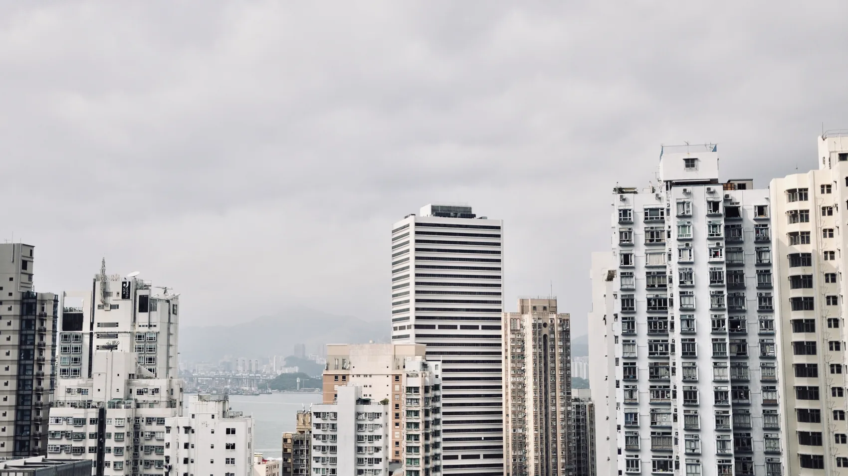 Hong Kong high-rises under a pale grey sky.