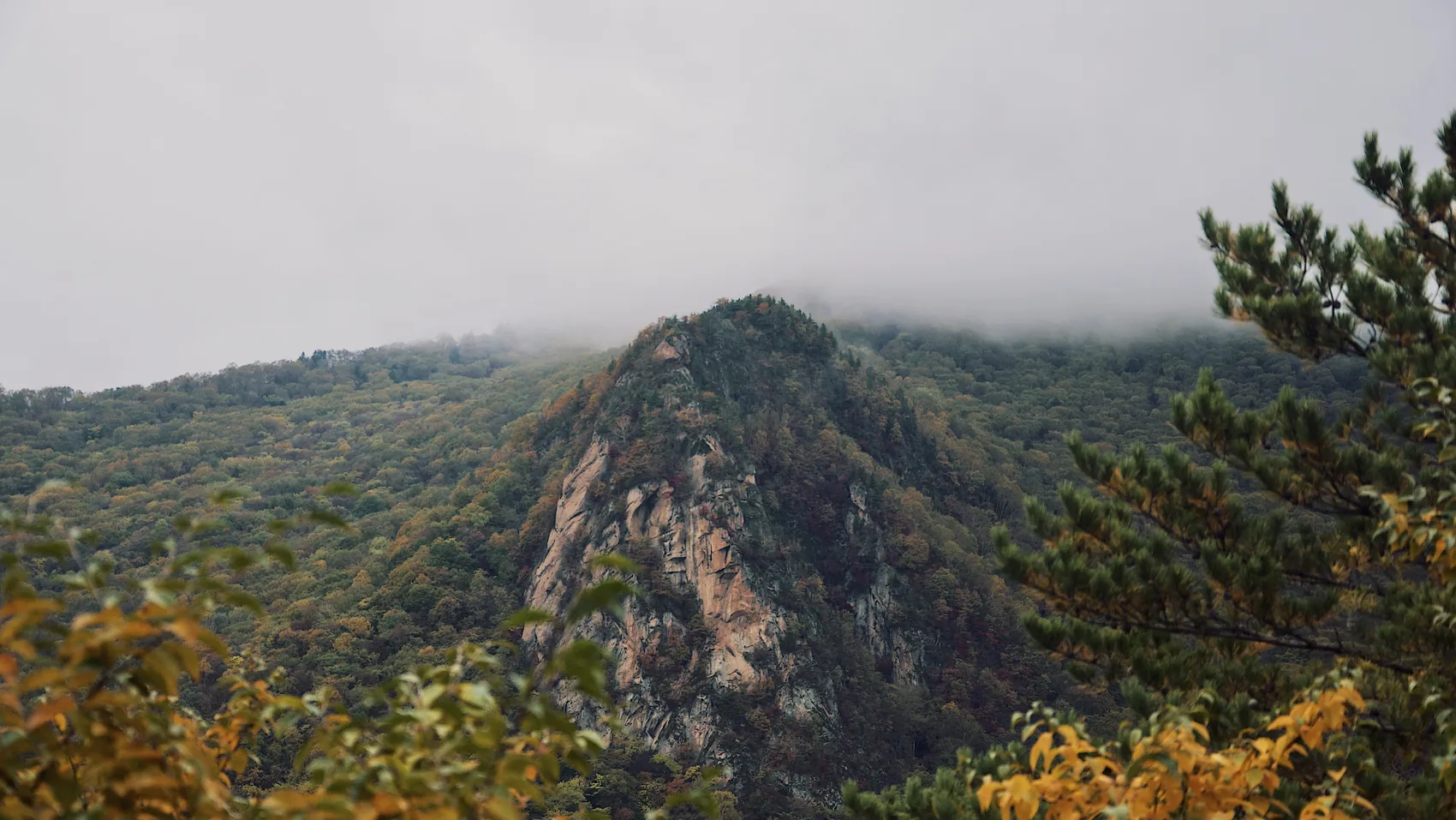 A rocky Jilin mountain under low mist.