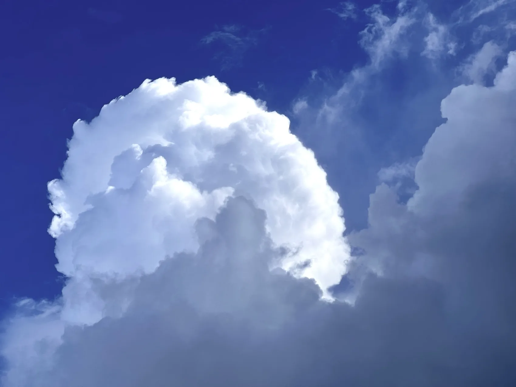 A bright cumulus cloud blooming over Jupiter.
