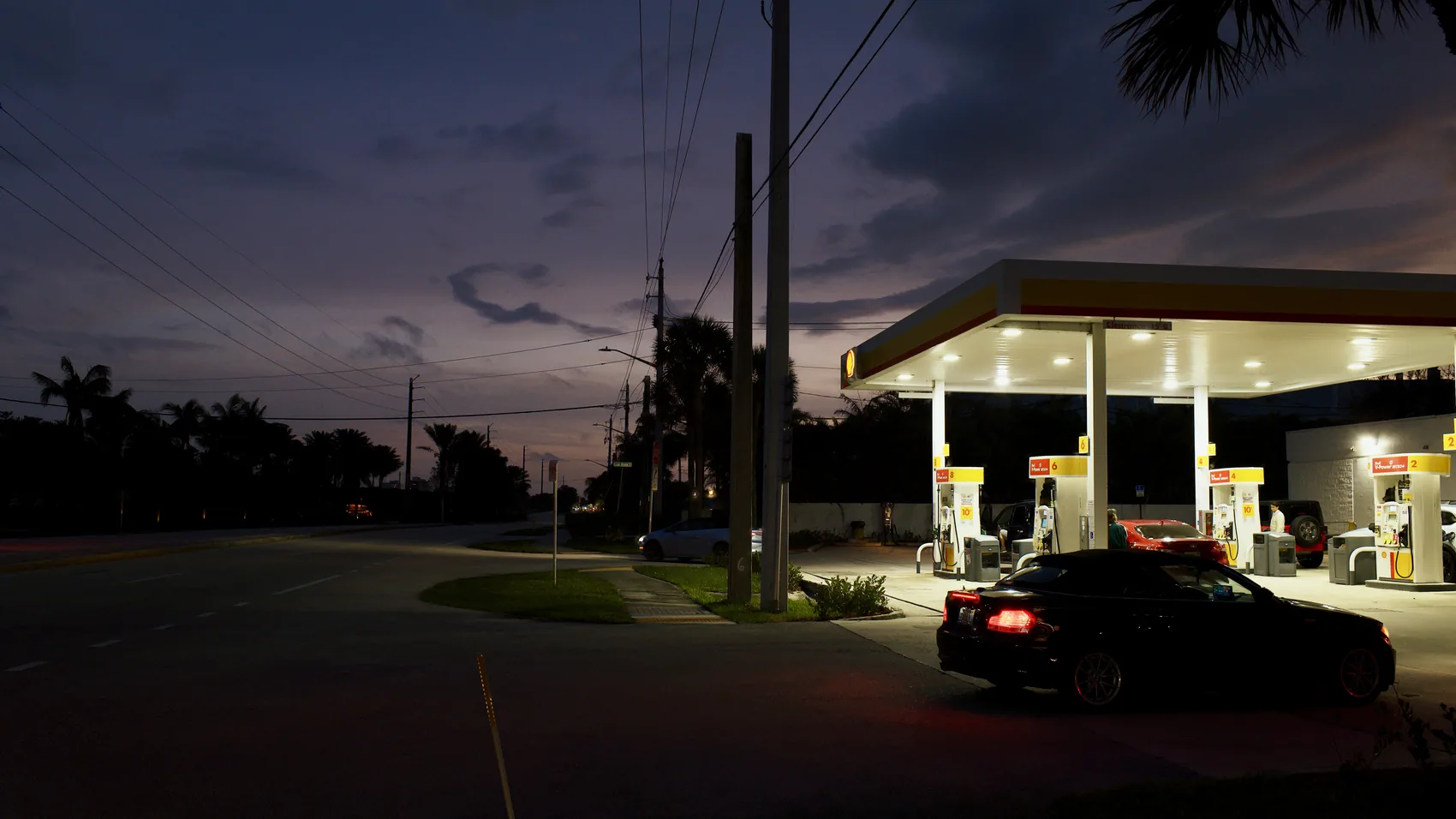 A Jupiter gas station under deep dusk sky.