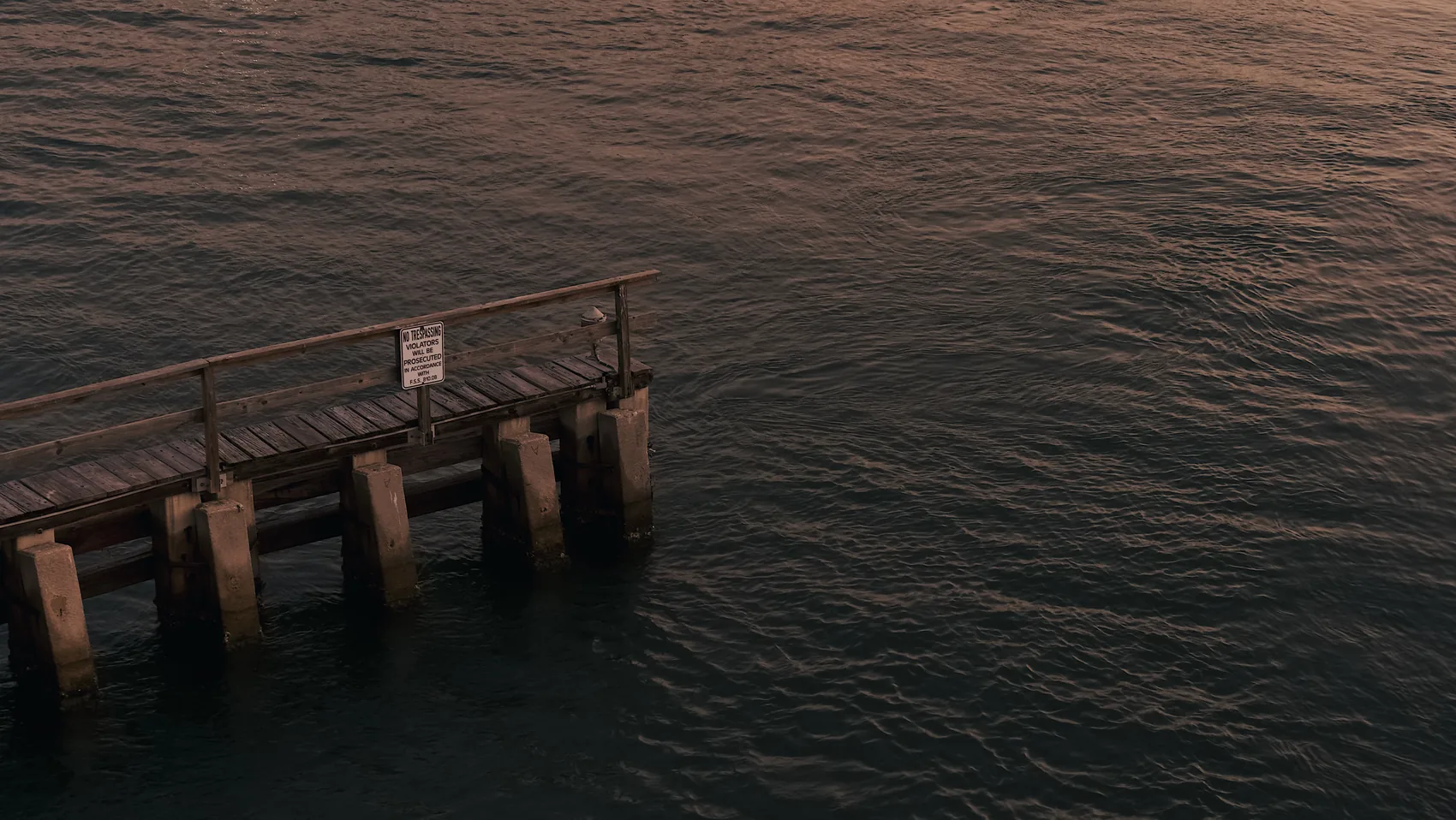 Jupiter pier pilings over dark rippled water.