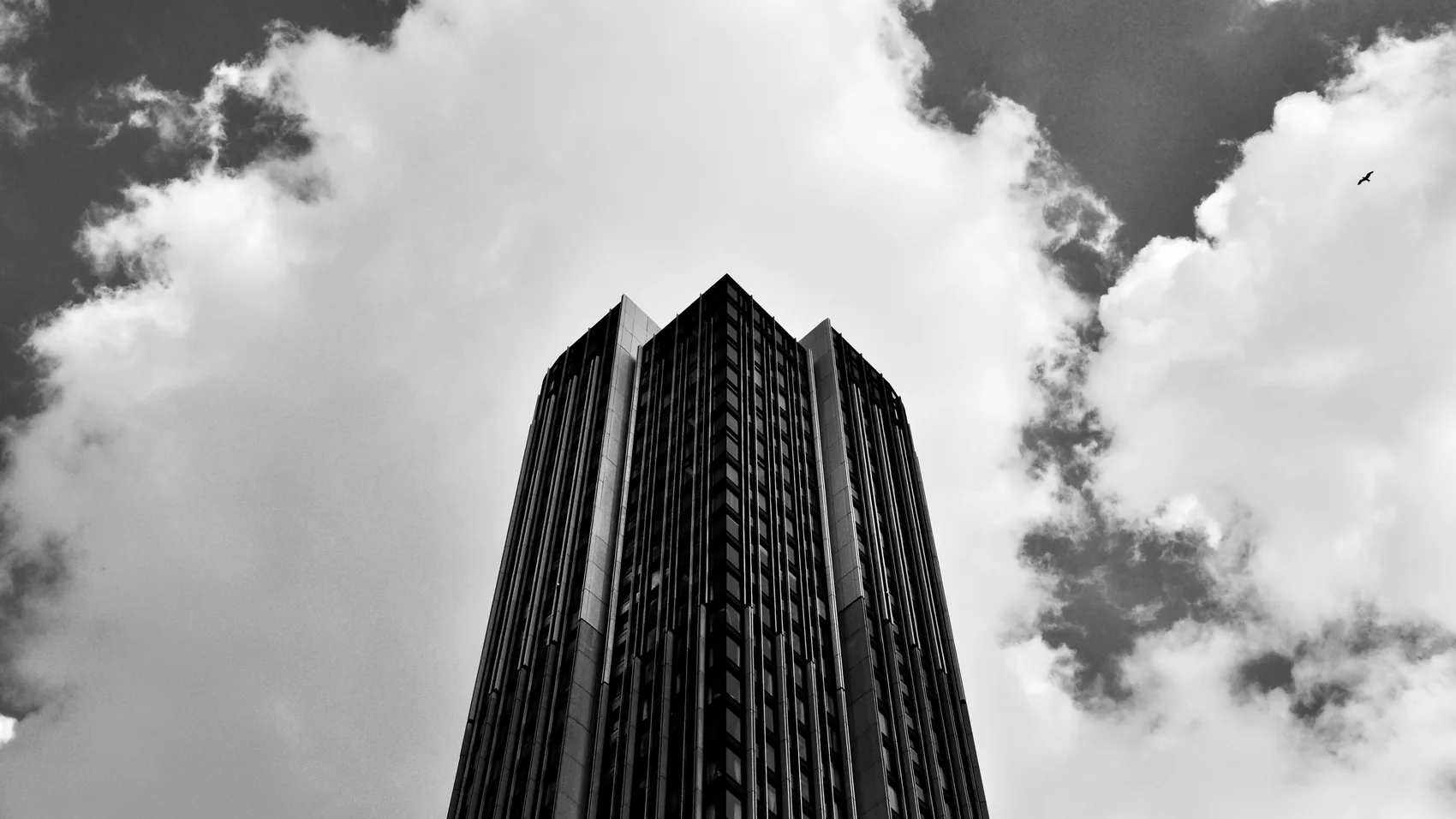 A black-and-white tower rising into cloud.