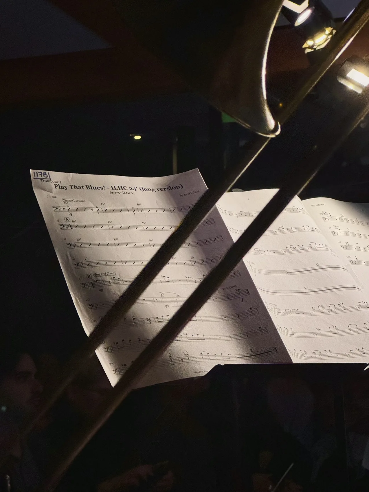 Sheet music on a dark New York music stand.