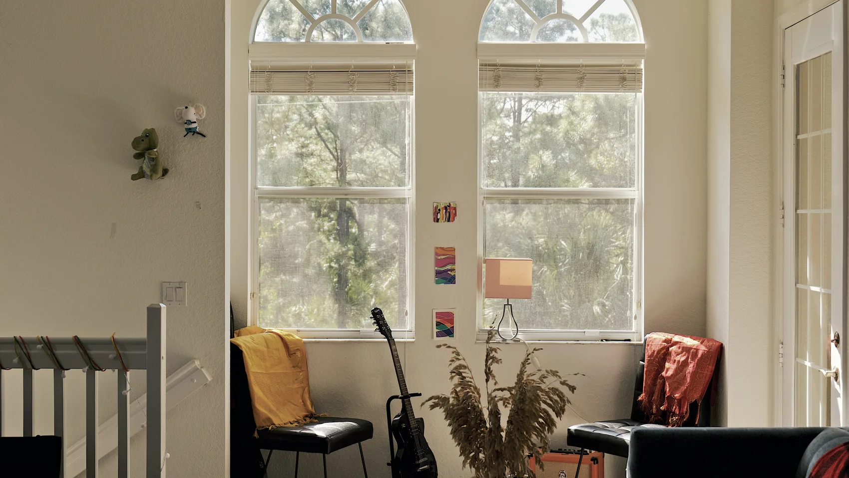 A bright Palm Beach Gardens living room with chairs and tall windows.
