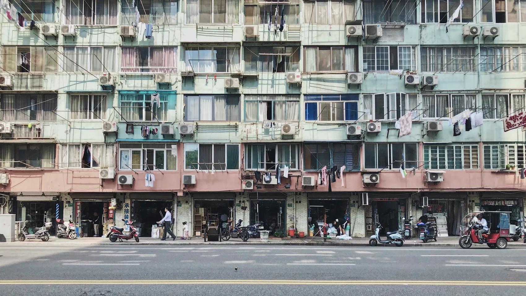 A Shanghai apartment facade packed with windows and air conditioners.