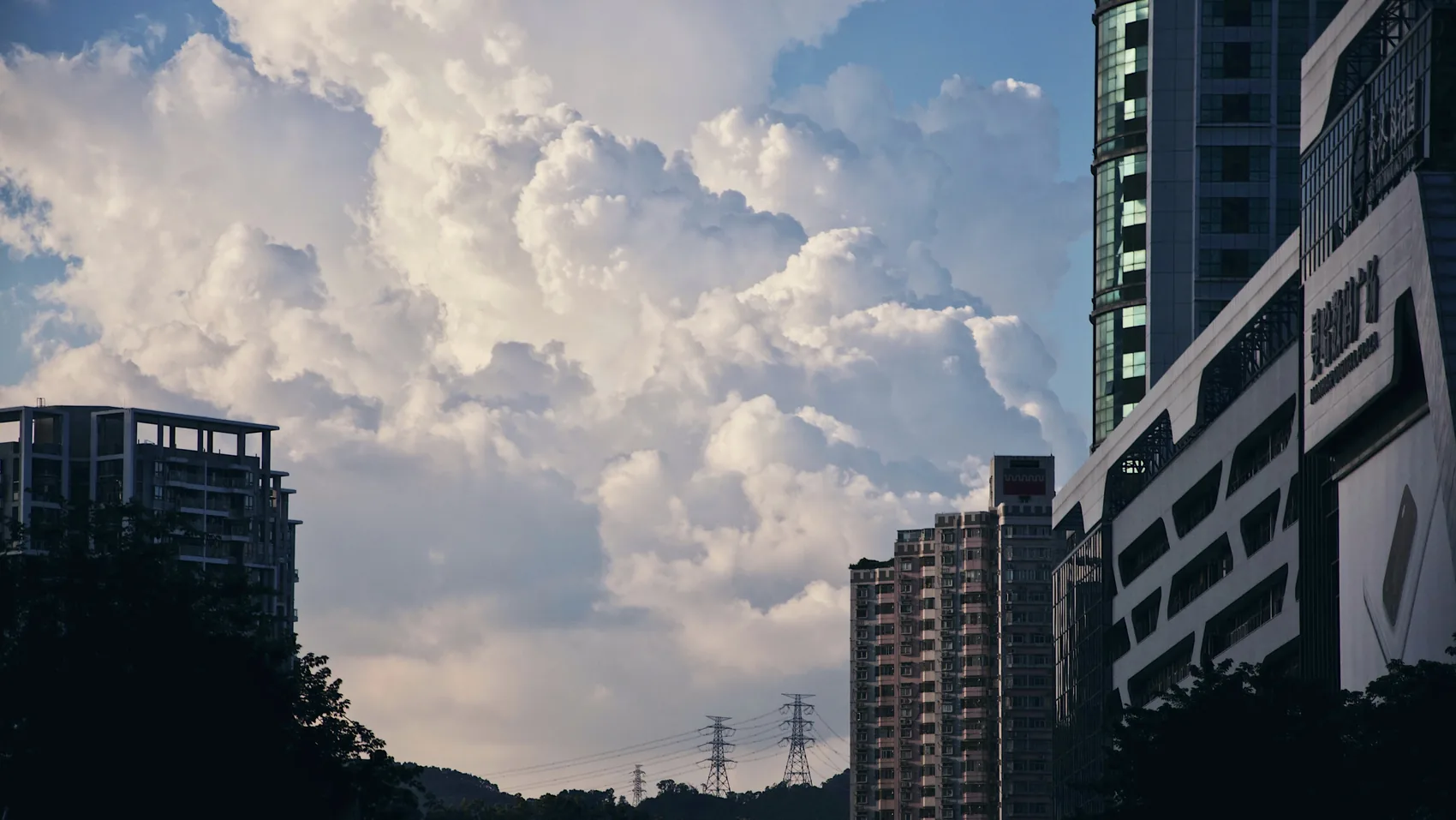 Large cumulus cloud rising over Shenzhen towers.