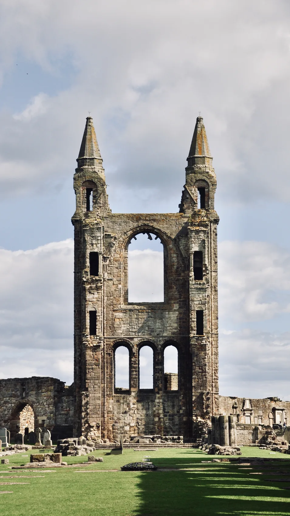 The St Andrews cathedral ruins standing against a pale sky.