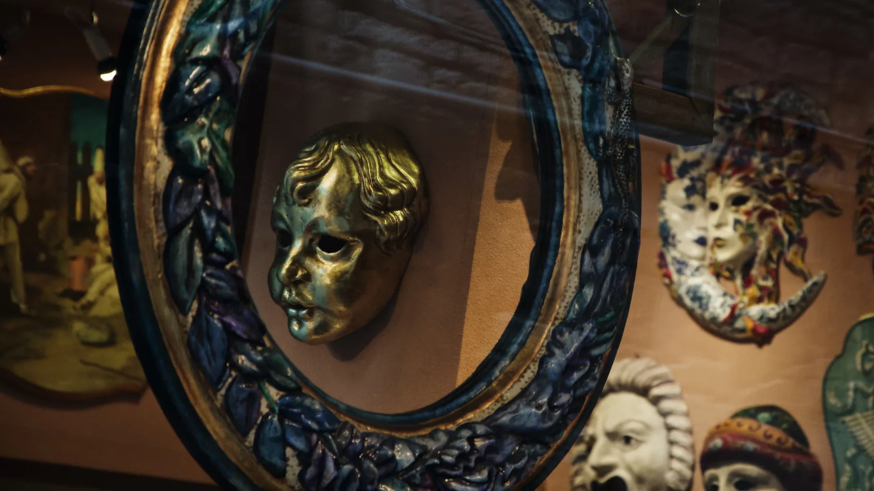 Venetian masks reflected in a shop mirror.