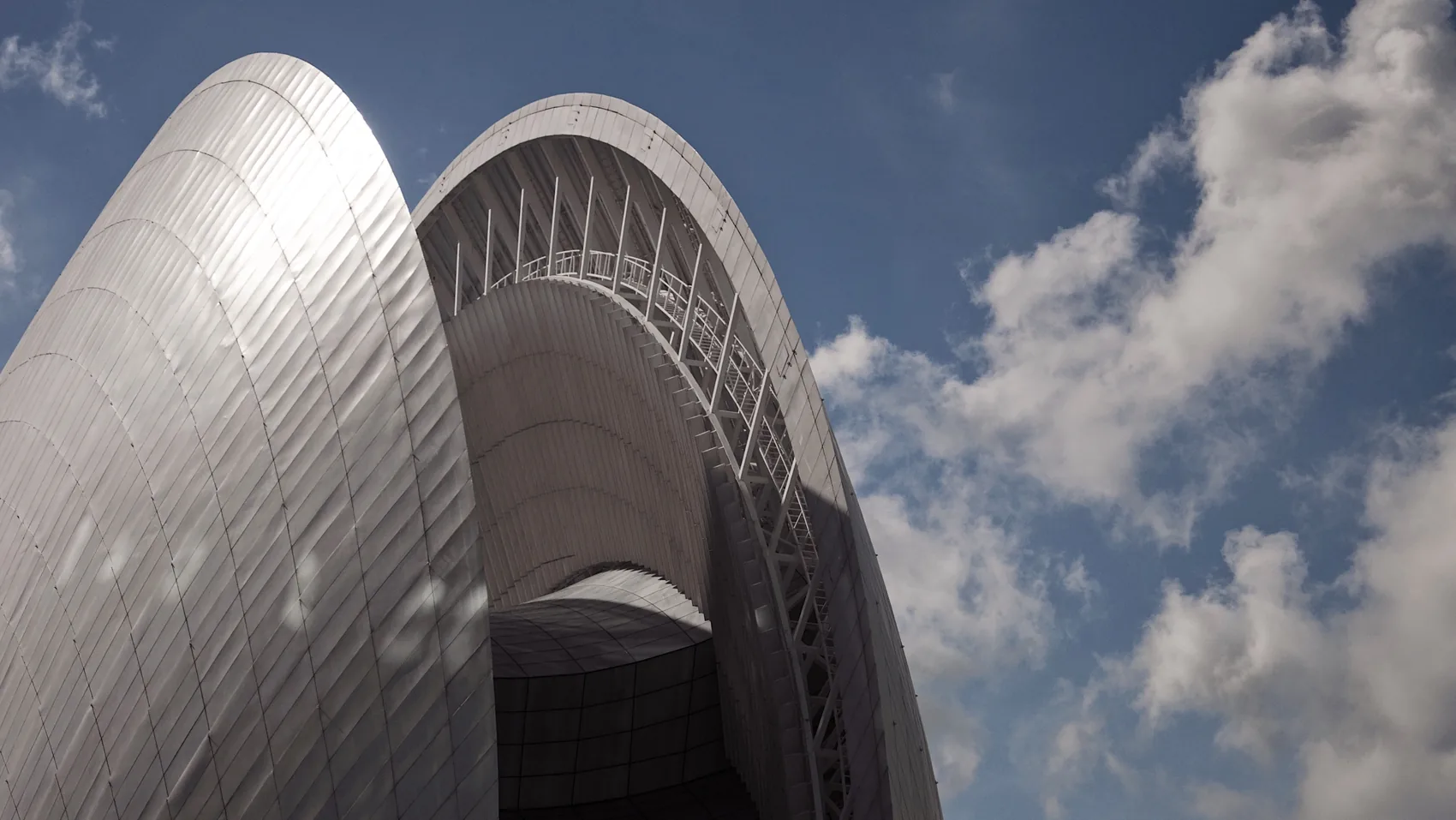 The Zhuhai opera shell curving into blue sky.
