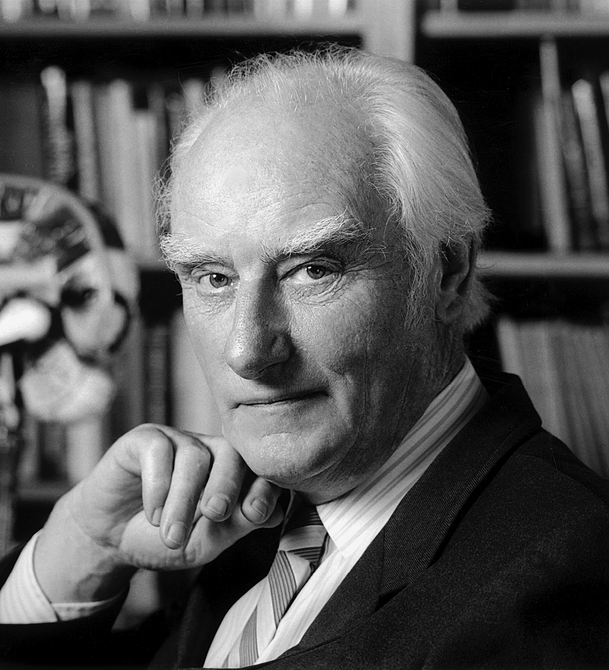 Francis Crick in his office at the Salk Institute, with a model of the human brain behind him — inherited from Jacob Bronowski.